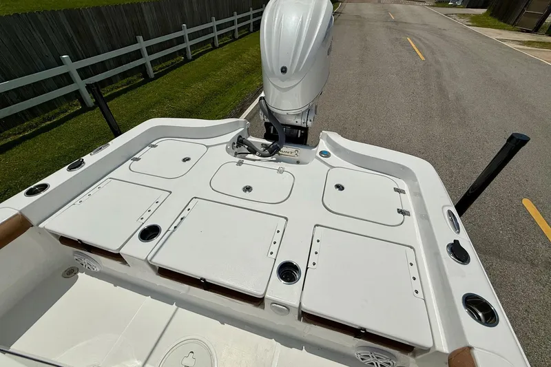 Slide: The Image of 2026 Sea Hunt BX25FS boat deck with storage compartments and outboard motor. - 8