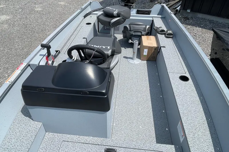 Slide: The Image of 2026 Lund 1600 Fury SS boat interior with steering wheel and seating. - 5