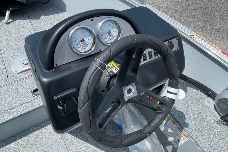 Slide: The Image of Steering console of 2026 Lund 1600 Fury SS boat with gauges and controls. - 9