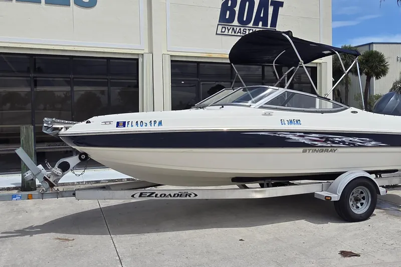 The Image of 2013 Stingray 194 LX boat on trailer outside dealership. - 0