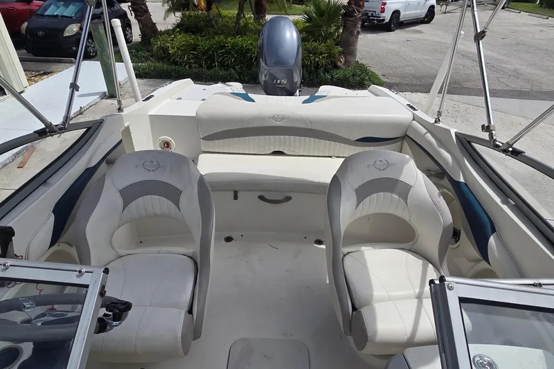 Slide: The Image of 2013 Stingray 194 LX boat interior with white seating and steering console. - 11