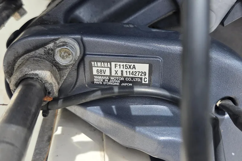 Slide: The Image of Close-up of Yamaha F115XA engine label on a 2013 Stingray 194 LX boat. - 13