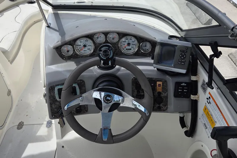 Slide: The Image of 2013 Stingray 194 LX boat dashboard with steering wheel, gauges, and Garmin GPS. - 5