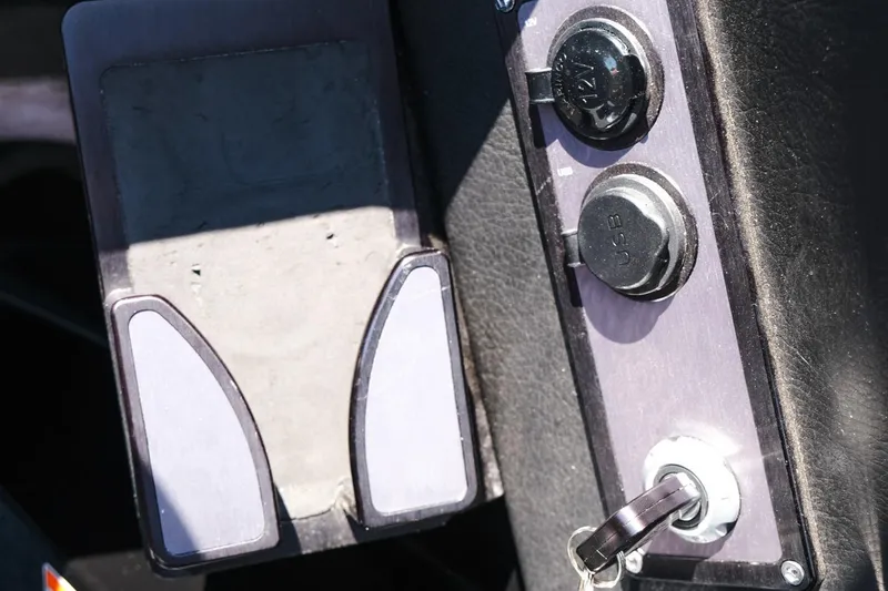 Slide: The Image of Dashboard of a 2023 MasterCraft XStar boat with USB ports and ignition key. - 14