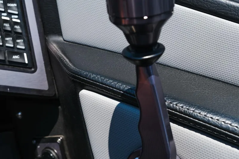 Slide: The Image of Close-up of 2023 MasterCraft XStar boat interior, featuring control panel and sleek design elements. - 15