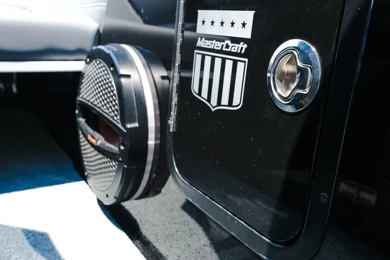 Slide: The Image of 2023 MasterCraft XStar boat interior with speaker and logo detail. - 22