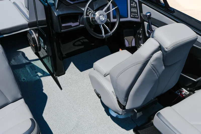 Slide: The Image of 2023 MasterCraft XStar interior with gray seating and modern steering wheel design. - 24