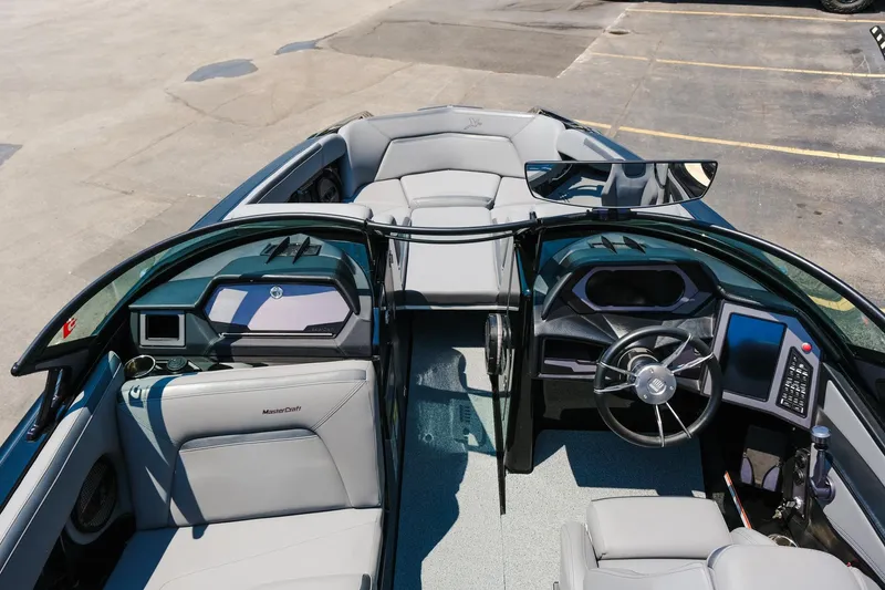 Slide: The Image of 2023 MasterCraft XStar boat interior with modern dashboard and seating. - 26