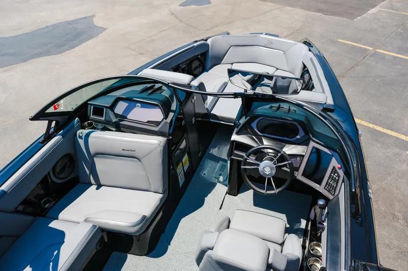Slide: The Image of 2023 MasterCraft XStar boat interior with sleek seating and modern dashboard design. - 27