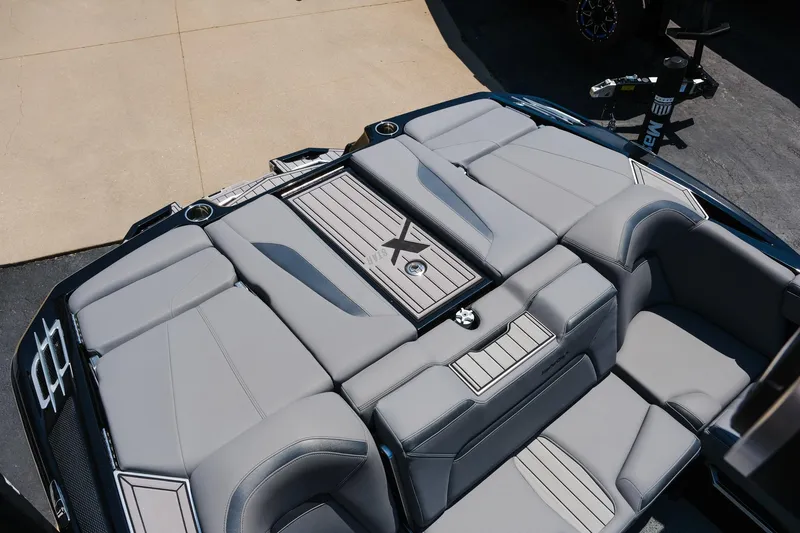 Slide: The Image of 2023 MasterCraft XStar boat interior with sleek gray seating and modern design. - 28