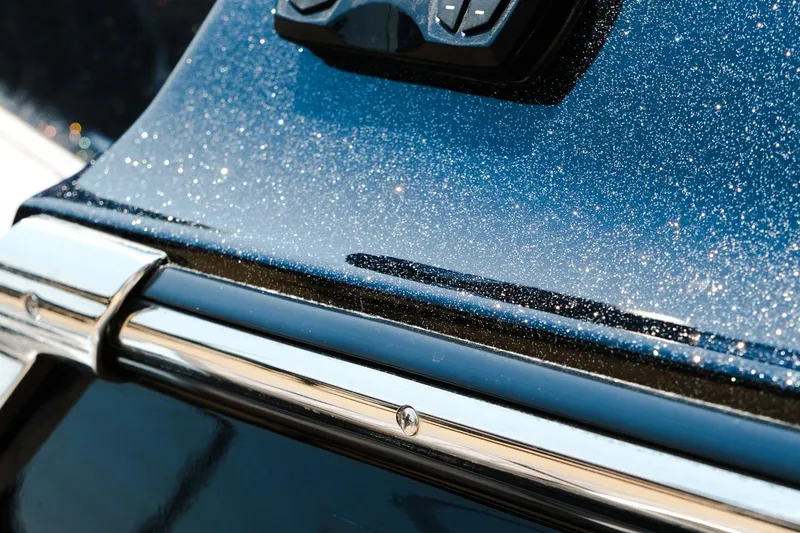 Slide: The Image of 2023 MasterCraft XStar boat with sparkling blue metallic finish and chrome detailing. - 30