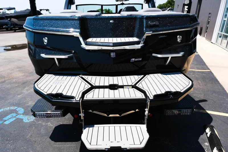 Slide: The Image of 2023 MasterCraft XStar boat rear view with swim platform and sleek design. - 5
