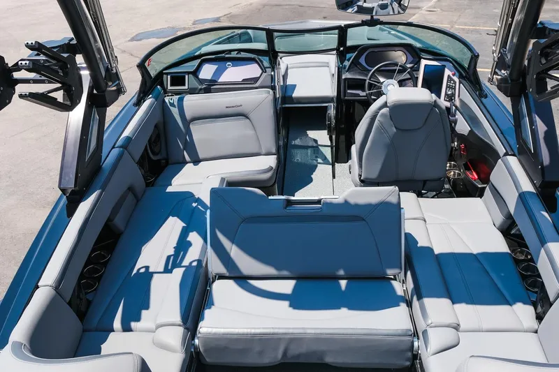 Slide: The Image of 2023 MasterCraft XStar boat interior with luxurious seating and modern dashboard. - 6
