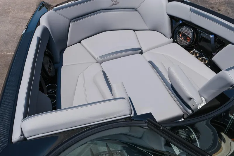 Slide: The Image of 2023 MasterCraft XStar boat interior with luxurious gray seating and premium audio system. - 7