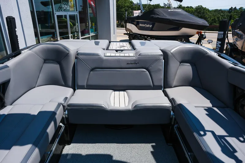 Slide: The Image of 2023 MasterCraft XStar boat interior with luxurious gray seating and modern design. - 8
