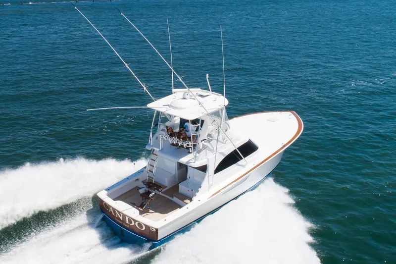 Slide: The Image of 2023 Viking 46 Billfish yacht cruising on open water, rear view. - 1