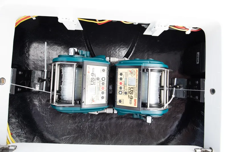 Slide: The Image of 2023 Viking 46 Billfish fishing equipment with dual electric reels in a storage compartment. - 14