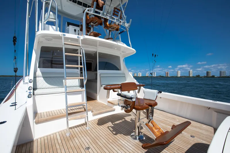 Slide: The Image of 2023 Viking 46 Billfish yacht with fishing chair, ocean view, and city skyline. - 18