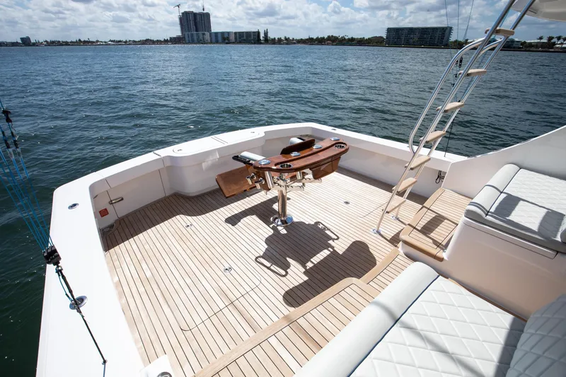 Slide: The Image of 2023 Viking 46 Billfish yacht deck with fishing chair, ocean view, and sunny weather. - 20