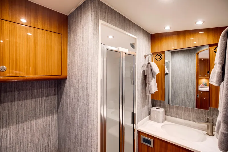 Slide: The Image of Luxurious bathroom in 2023 Viking 46 Billfish yacht with modern fixtures and elegant wood finishes. - 21