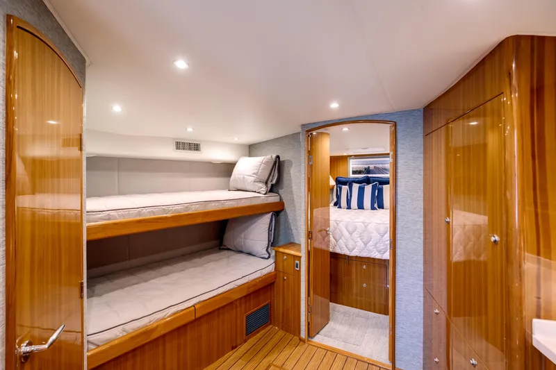 Slide: The Image of Luxurious interior of 2023 Viking 46 Billfish yacht with cozy bunk beds and elegant wood finish. - 22