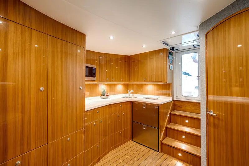 Slide: The Image of Luxurious interior of 2023 Viking 46 Billfish yacht with wooden cabinetry and modern amenities. - 23