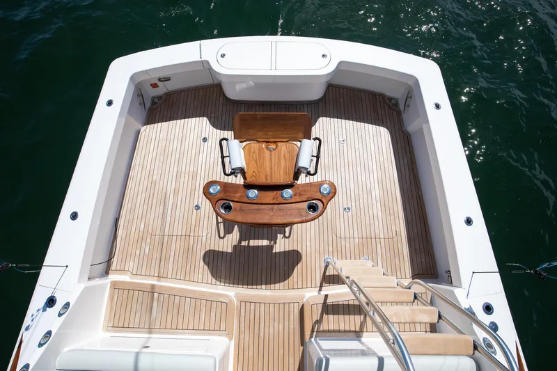 Slide: The Image of 2023 Viking 46 Billfish boat deck with wooden flooring and fishing chair. - 8
