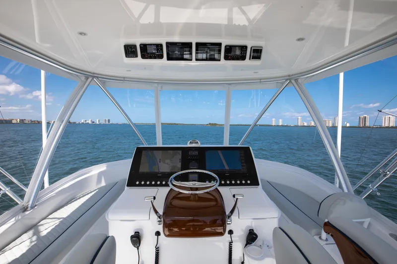Slide: The Image of 2023 Viking 46 Billfish helm with ocean view, featuring modern navigation controls. - 9