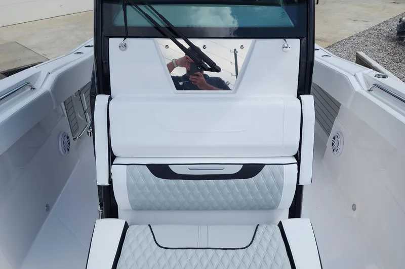 Slide: The Image of 2026 Blackfin 272 CC boat interior with white quilted seating and sleek design. - 13