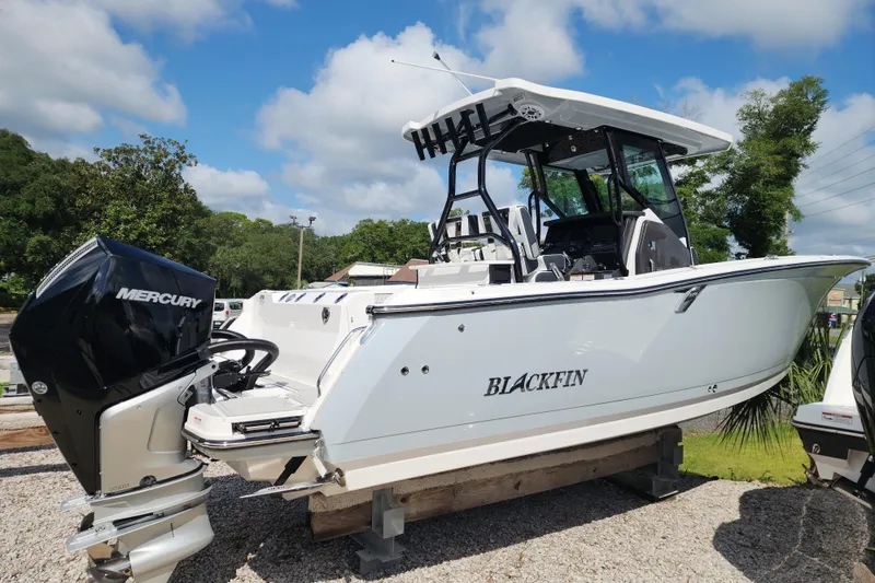 Slide: The Image of 2026 Blackfin 272 CC boat with Mercury engine on display outdoors. - 2