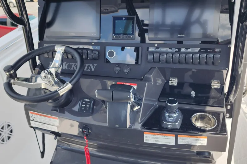 Slide: The Image of 2026 Blackfin 272 CC boat dashboard with steering wheel and control panel. - 8