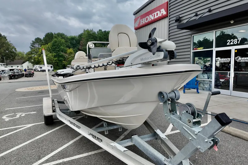 Slide: The Image of 2023 Carolina Skiff 178 boat on trailer outside Honda dealership. - 12