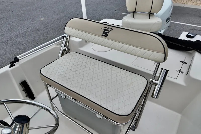 Slide: The Image of 2023 Carolina Skiff 178 boat interior with cushioned seating and steering wheel. - 3