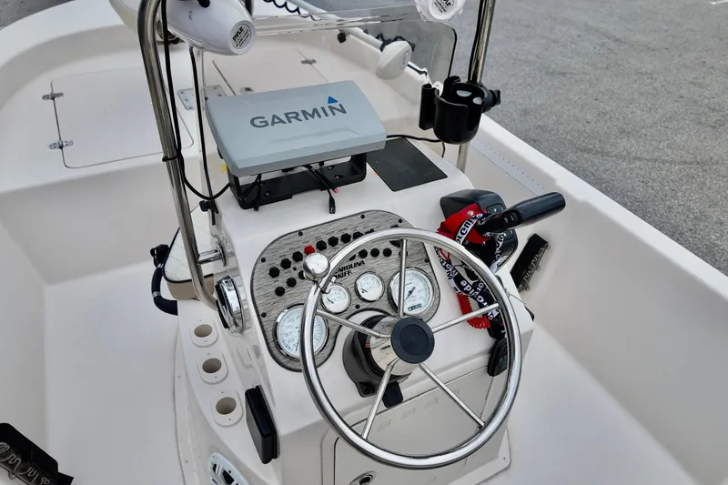 Slide: The Image of 2023 Carolina Skiff 178 boat console with Garmin navigation system and steering wheel. - 4