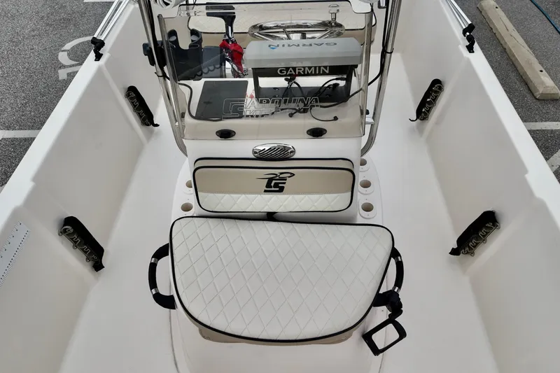 Slide: The Image of 2023 Carolina Skiff 178 boat interior with Garmin equipment and cushioned seating. - 5