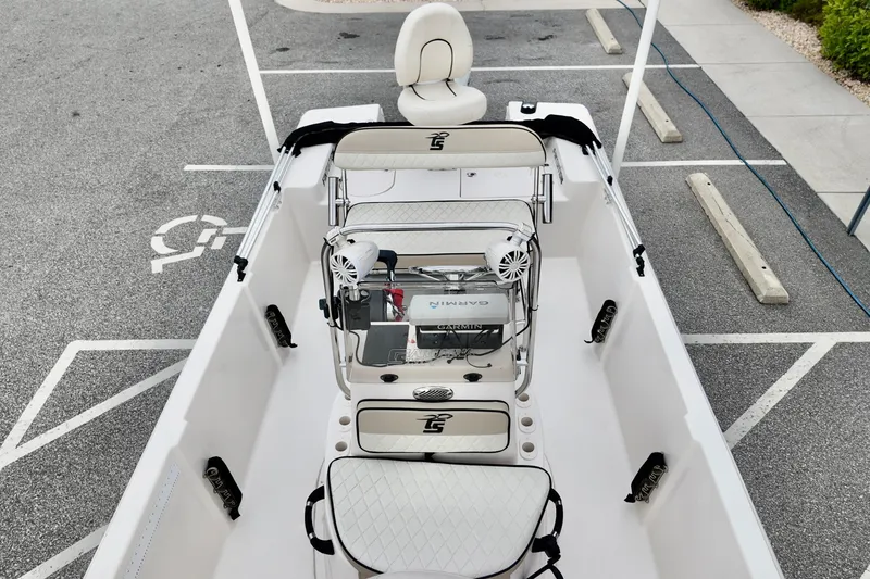 Slide: The Image of 2023 Carolina Skiff 178 boat interior with seating and equipment, parked in a lot. - 6