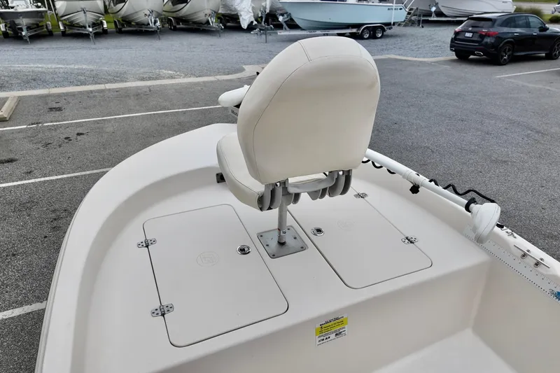 Slide: The Image of 2023 Carolina Skiff 178 boat with white seating and storage compartments. - 7