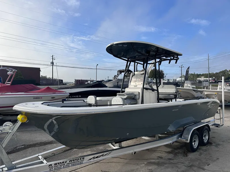 The Image of 2025 Carolina Skiff 24 Ultra Elite boat on trailer, parked outdoors under a clear sky. - 18