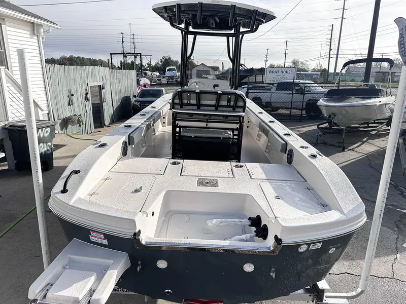 Slide: The Image of 2026 Carolina Skiff 22 Ultra Elite boat with Suzuki outboard motor at indoor exhibition. - 22