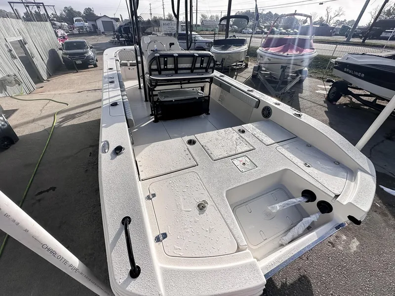 Slide: The Image of 2026 Carolina Skiff 22 Ultra Elite boat, docked with spacious seating and modern design. - 23