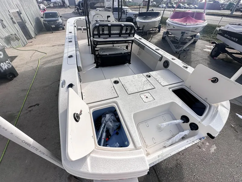 Slide: The Image of 2026 Carolina Skiff 22 Ultra Elite boat interior with seating and console, docked outdoors. - 24