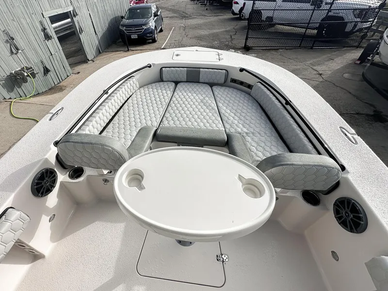 Slide: The Image of 2026 Carolina Skiff 22 Ultra Elite boat on trailer, parked outside a building. - 30