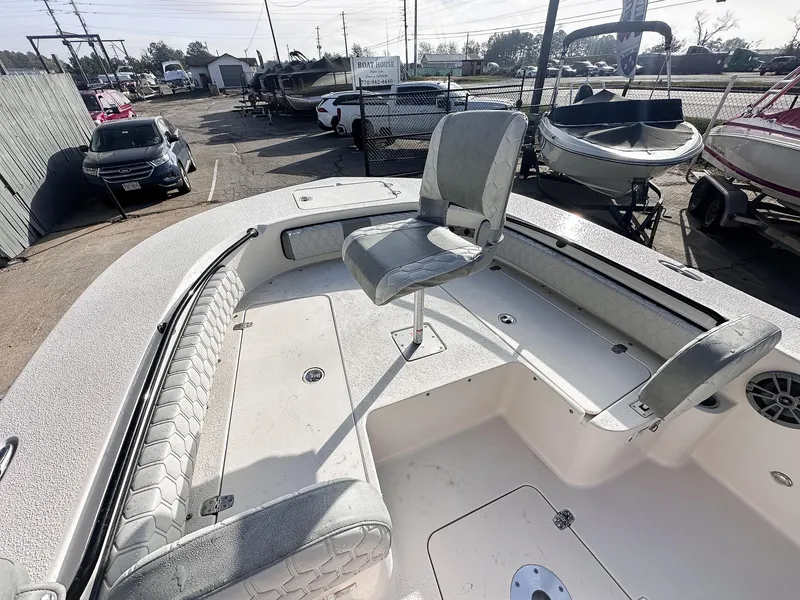 Slide: The Image of 2026 Carolina Skiff 22 Ultra Elite boat docked at a marina under clear blue skies. - 36
