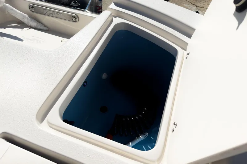 Slide: The Image of Open storage compartment on 2026 Carolina Skiff 22 Ultra Elite boat. - 43