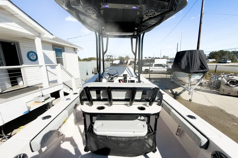 Slide: The Image of 2026 Carolina Skiff 22 Ultra Elite boat interior at a marina, showcasing helm and seating. - 47