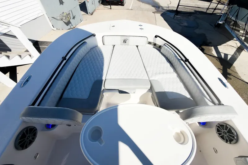 Slide: The Image of 2026 Carolina Skiff 22 Ultra Elite boat interior with cushioned seating and table. - 60