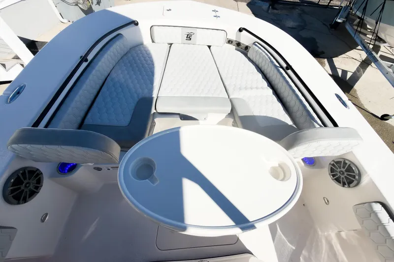 Slide: The Image of 2026 Carolina Skiff 22 Ultra Elite boat interior with cushioned seating and round table. - 61