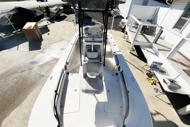 Slide: The Image of 2026 Carolina Skiff 22 Ultra Elite boat, top view, docked near a house. - 67