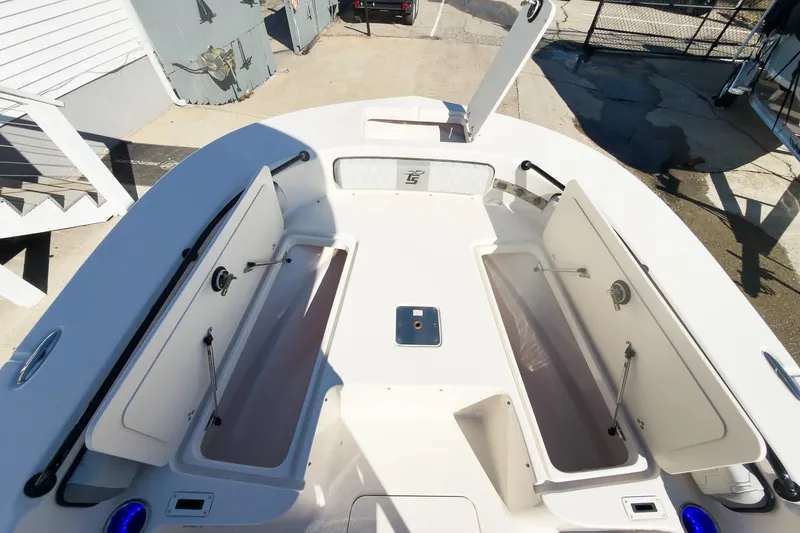Slide: The Image of 2026 Carolina Skiff 22 Ultra Elite boat deck with open storage compartments. - 68