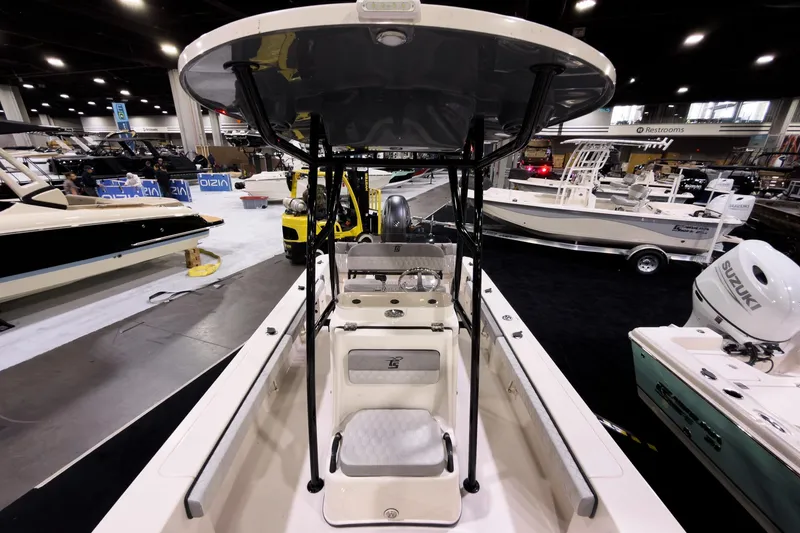 Slide: The Image of 2026 Carolina Skiff 22 Ultra Elite boat displayed at an indoor boat show. - 78